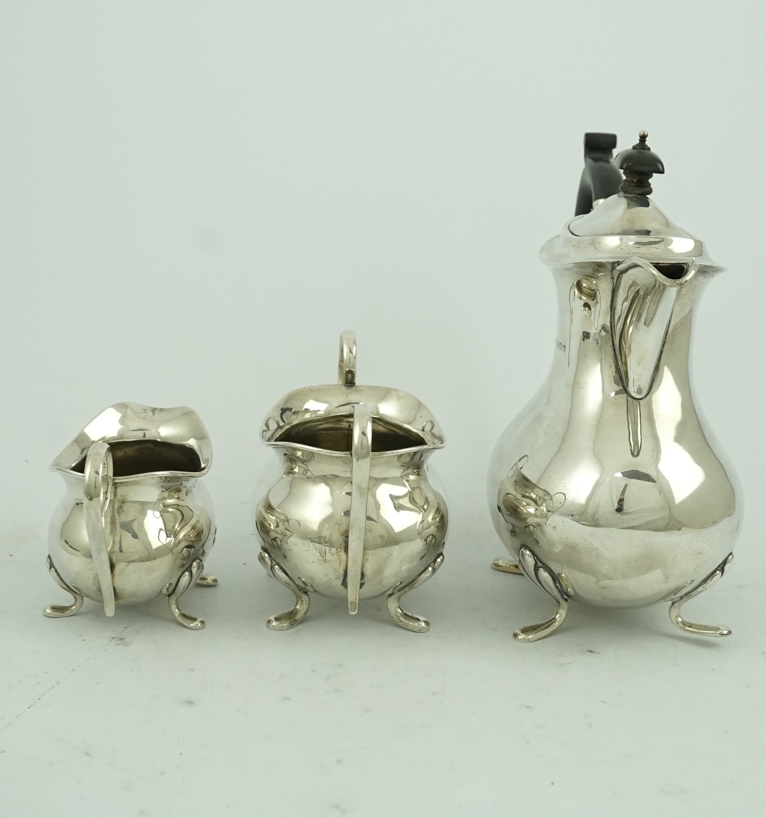 A George V matched silver three piece tea set by Joseph Gloster Ltd